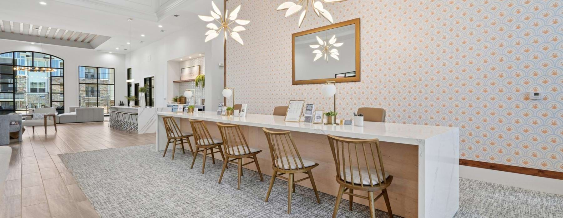 a spacious room with a chandelier and chairs