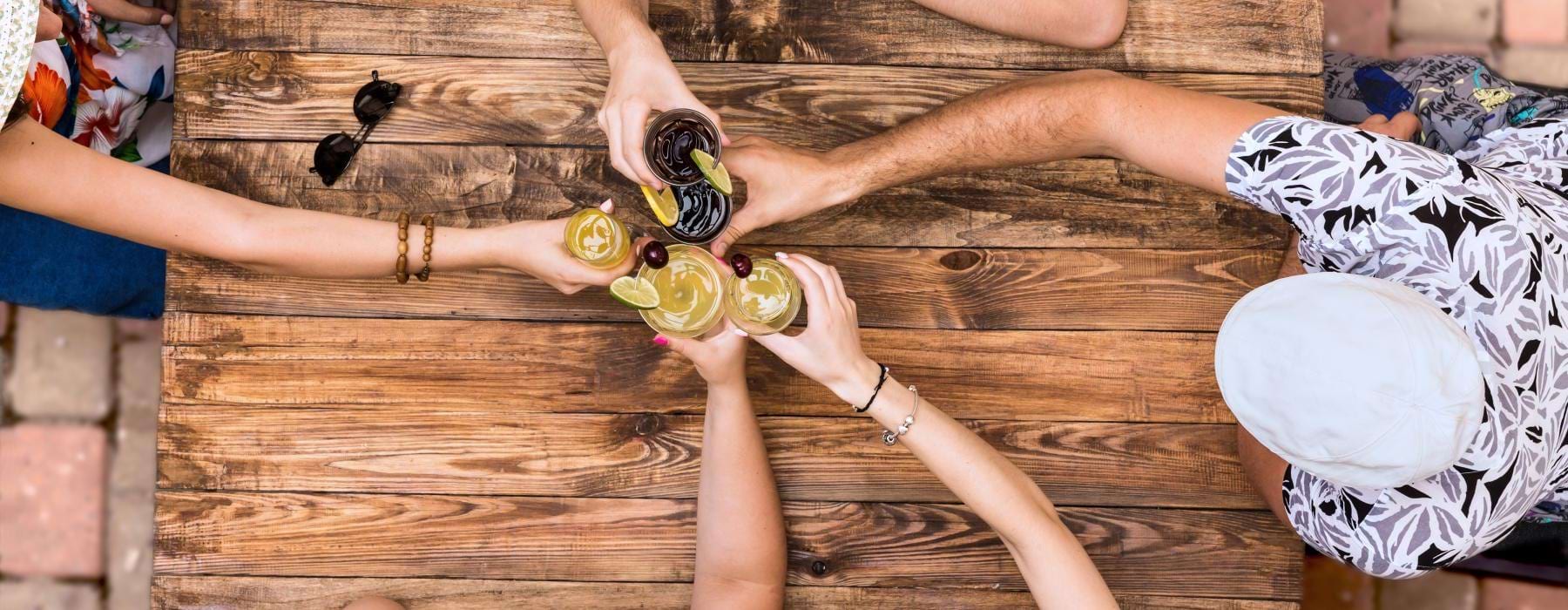 a group of people holding bottles